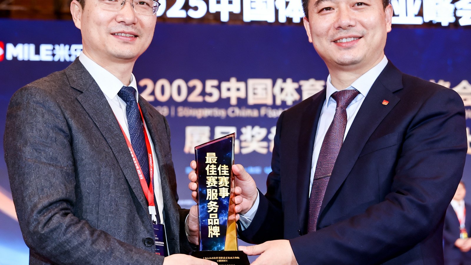 MILE米乐在2025中国体育产业峰会上荣获'最佳赛事服务品牌'奖项的领奖照片。